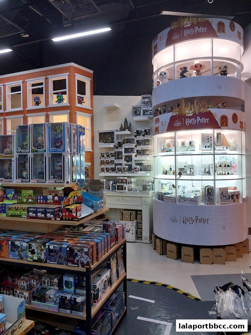 Interior of a toy store with shelves full of branded merchandise, including Harry Potter items.
