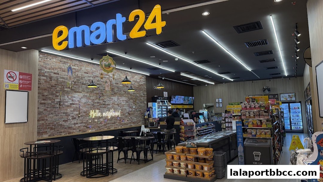 Interior view of an emart24 convenience store with seating area and shelves stocked with products.
