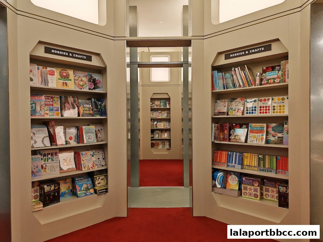 Interior view of a bookstore with shelves displaying books and craft supplies.