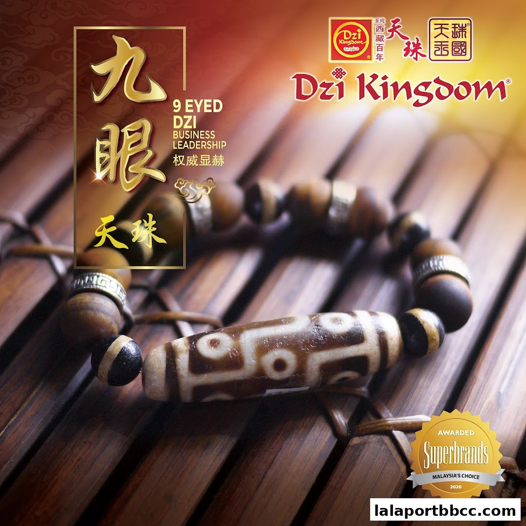 A close-up of a Dzi bead bracelet, highlighting its intricate patterns and the shop's branding.