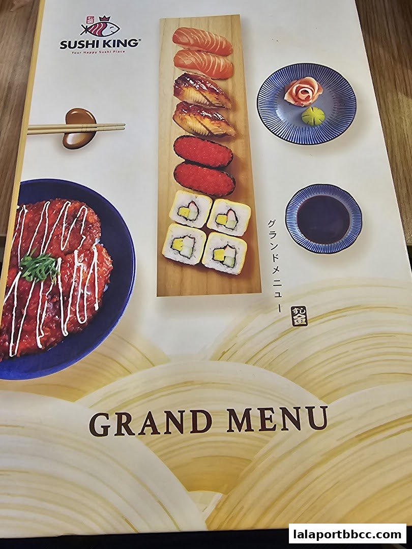 A menu from Sushi King featuring various sushi items and a dish with sauce.