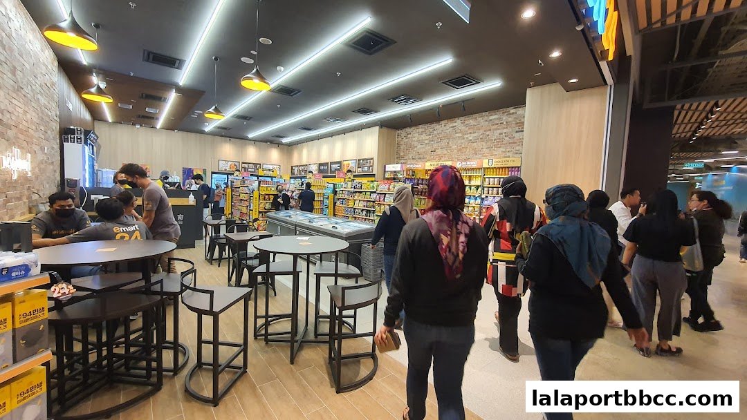 Interior view of an emart24 convenience store with customers and products on shelves.
