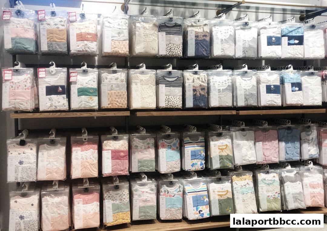 Shelves filled with neatly packaged baby clothes in various colors and patterns.