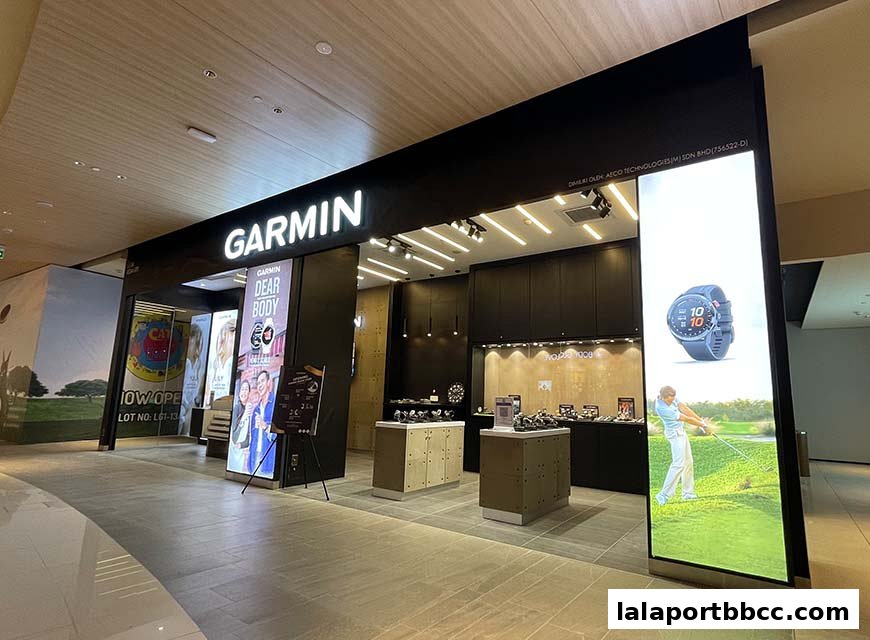 The exterior of a modern Garmin brand store with illuminated signage and product displays.
