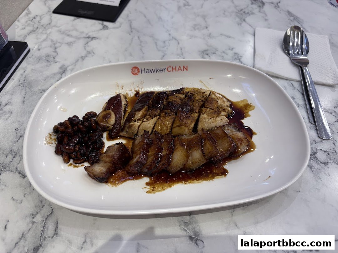 A plate of delicious roasted chicken and pork with soy sauce and beans.