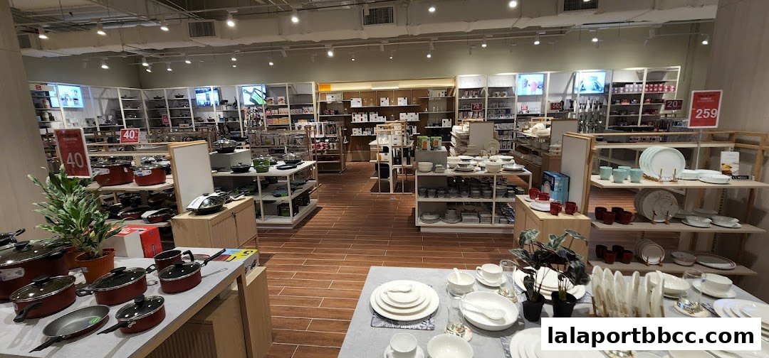 Interior view of a well-lit home goods store showcasing cookware and dinnerware.
