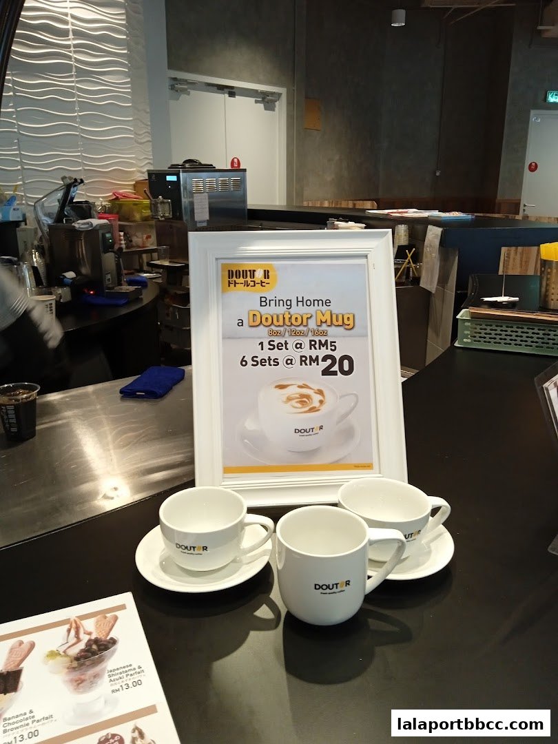 A display of Doutor Coffee mugs and a promotion for Doutor Mugs.