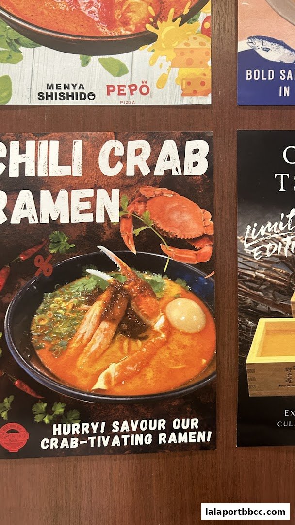 A poster advertising Menya Shishido's Chili Crab Ramen, featuring a bowl of ramen with crab.