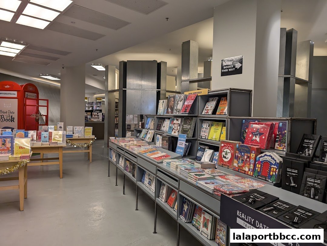 Interior of a bookstore with displays of books and red phone booths.