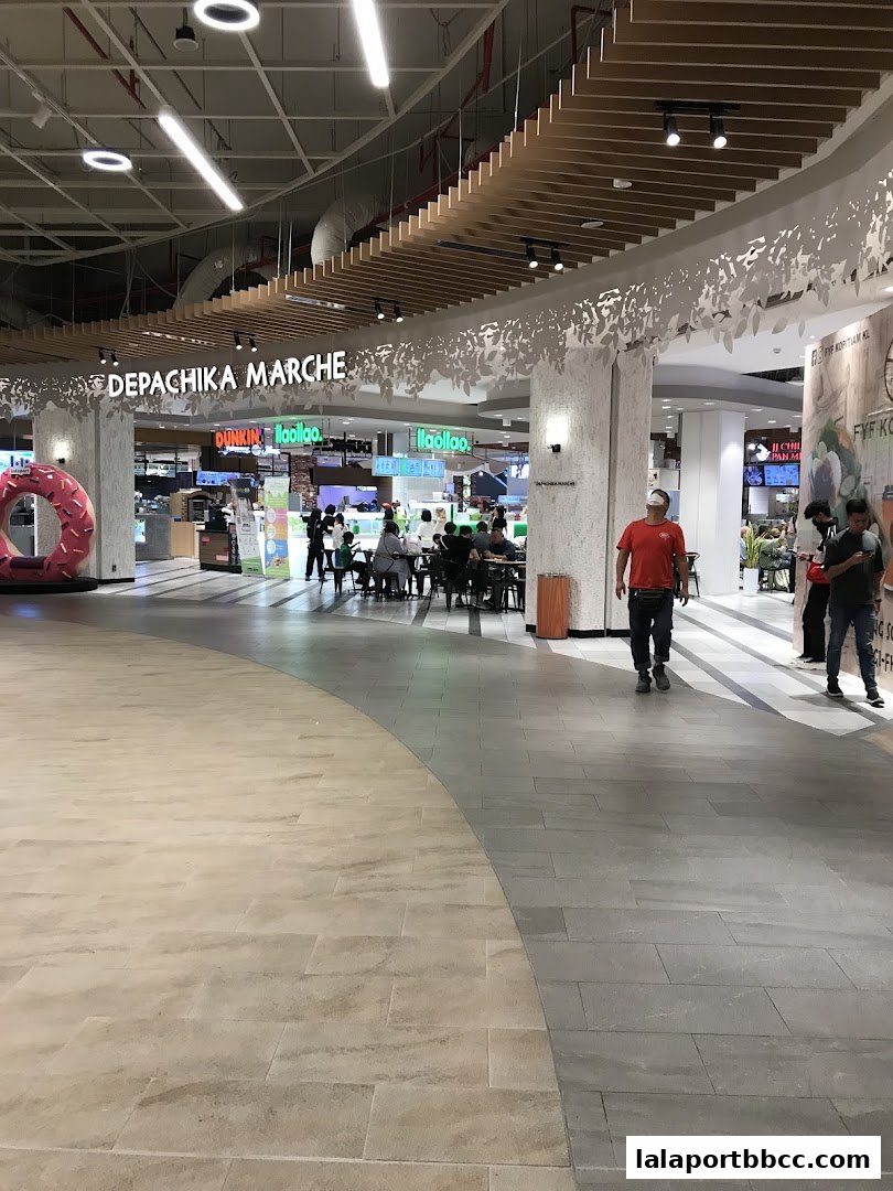A food hall with various eateries and seating areas, featuring the 'Depachika Marche' sign.