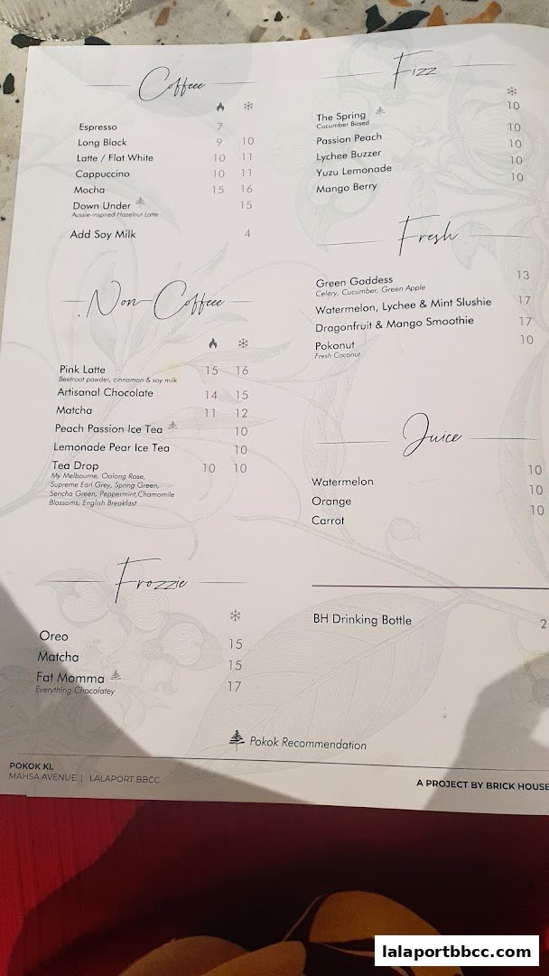 A menu from POKOK KL featuring coffee, non-coffee drinks, fizz, fresh juices, and frozzie options.