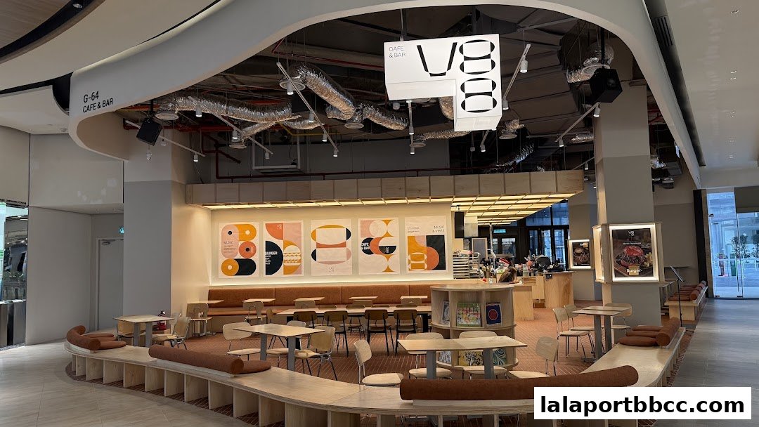 Interior view of V88 Cafe and Bar with modern seating, artwork, and a counter.