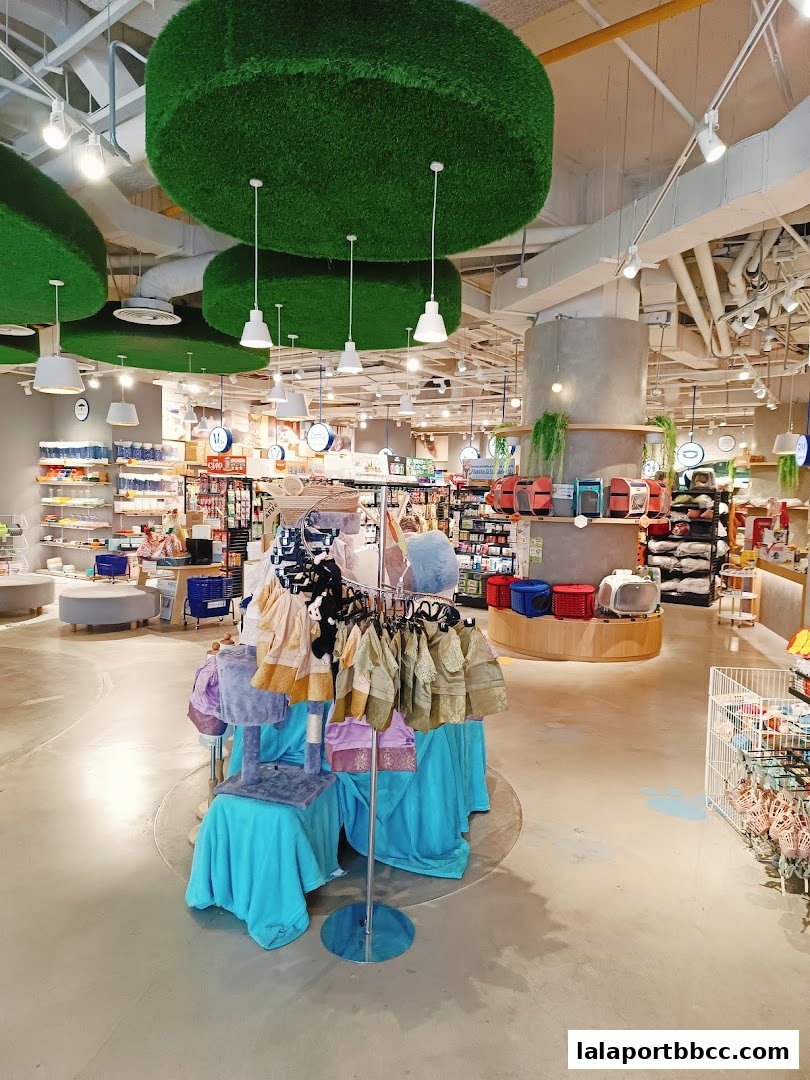 Interior of a pet shop with clothing and accessories displayed.