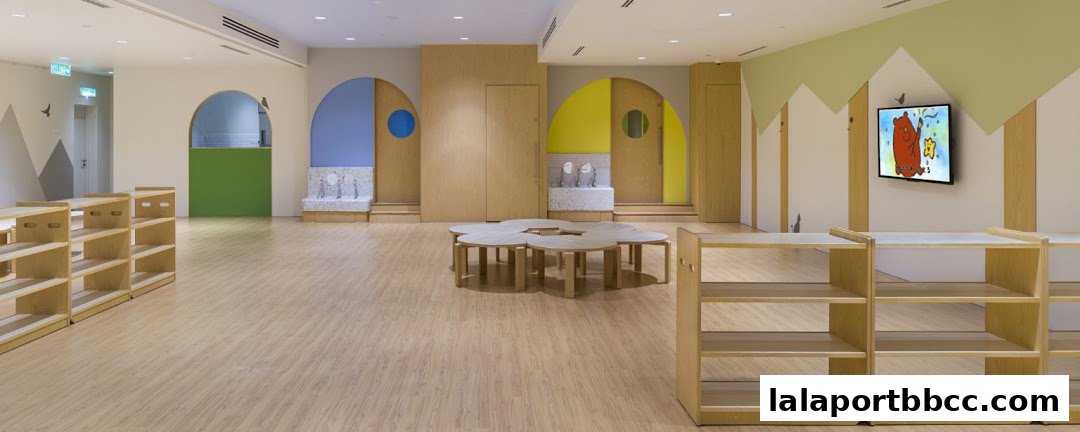 Interior of a brightly lit, modern child care center with colorful accents and child-sized furniture.