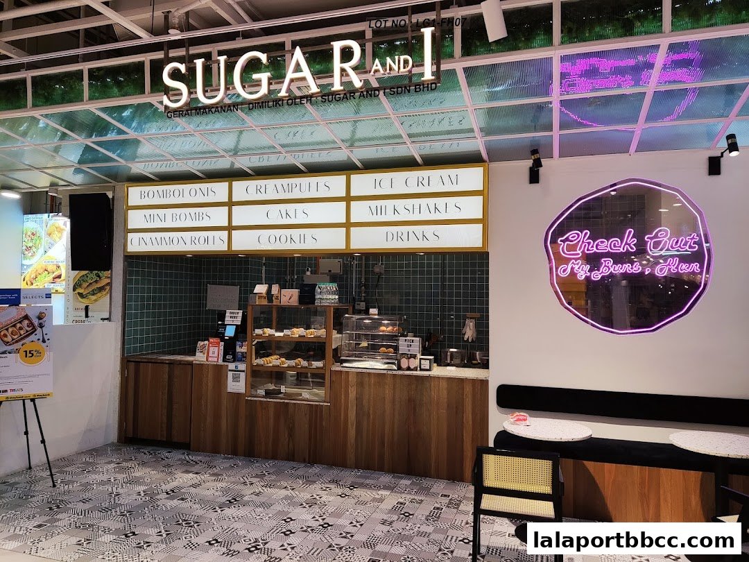 A modern bakery counter with a menu board displaying various sweet treats and drinks.