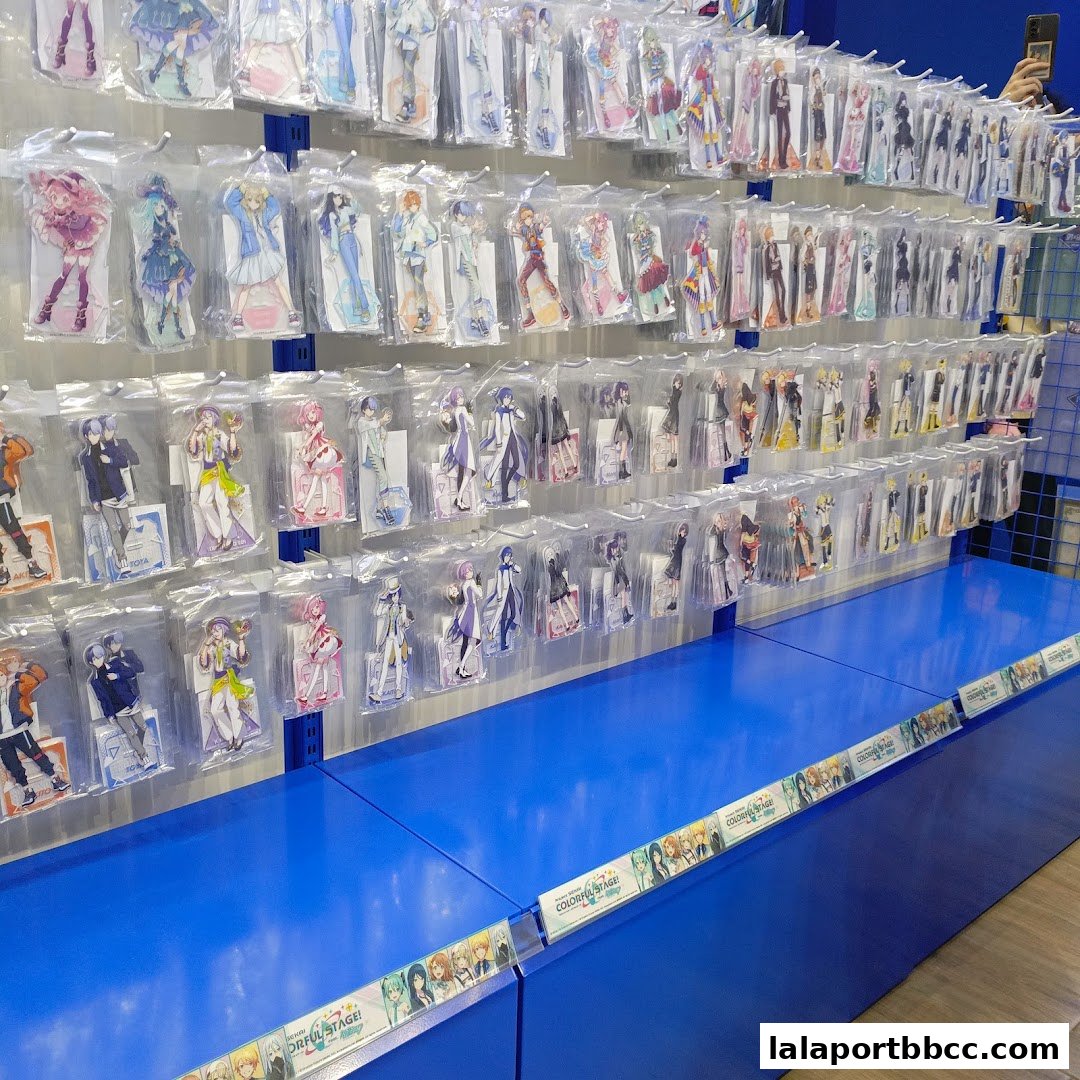 Wall display of anime character acrylic stands in plastic packaging.