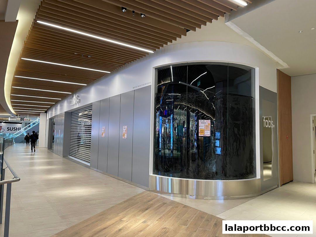 The exterior of the Fabs shop in a modern shopping mall with a curved glass display.