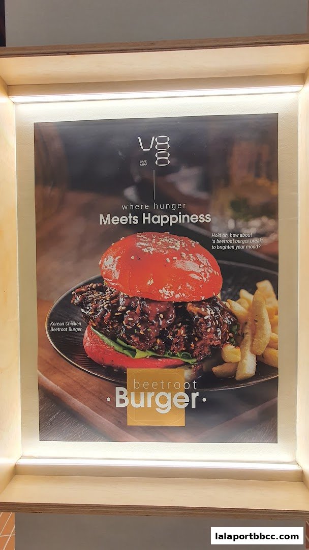 A poster advertising a Korean Chicken Beetroot Burger with fries from V8 Cafe and Bar.