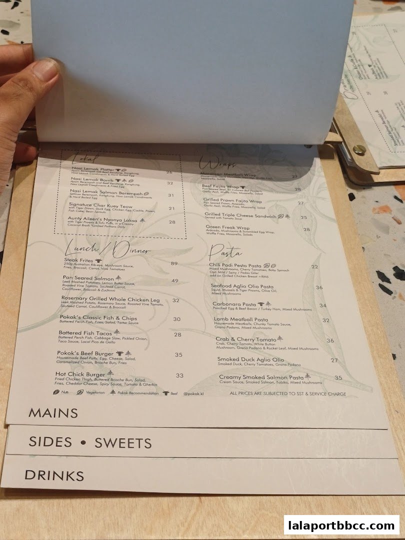A menu from POKOK LaLaport with sections for Mains, Sides, Sweets, and Drinks.