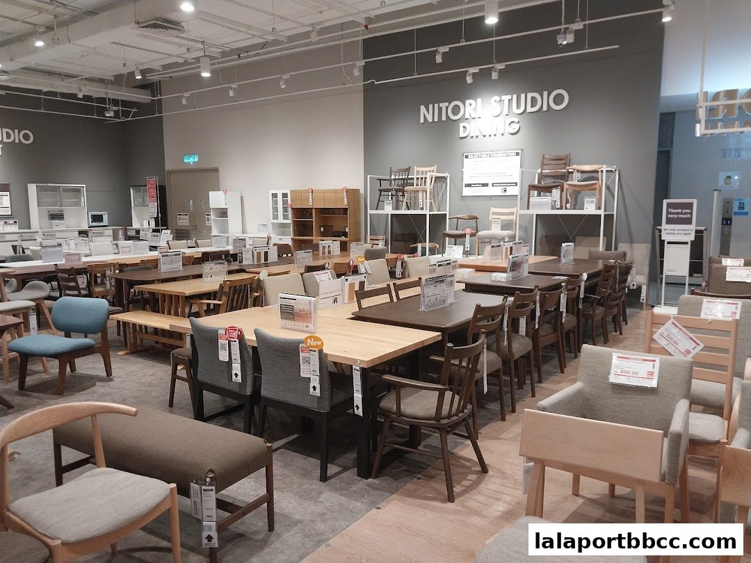 Interior view of a NITORI STUDIO DINING store showcasing various dining tables and chairs.