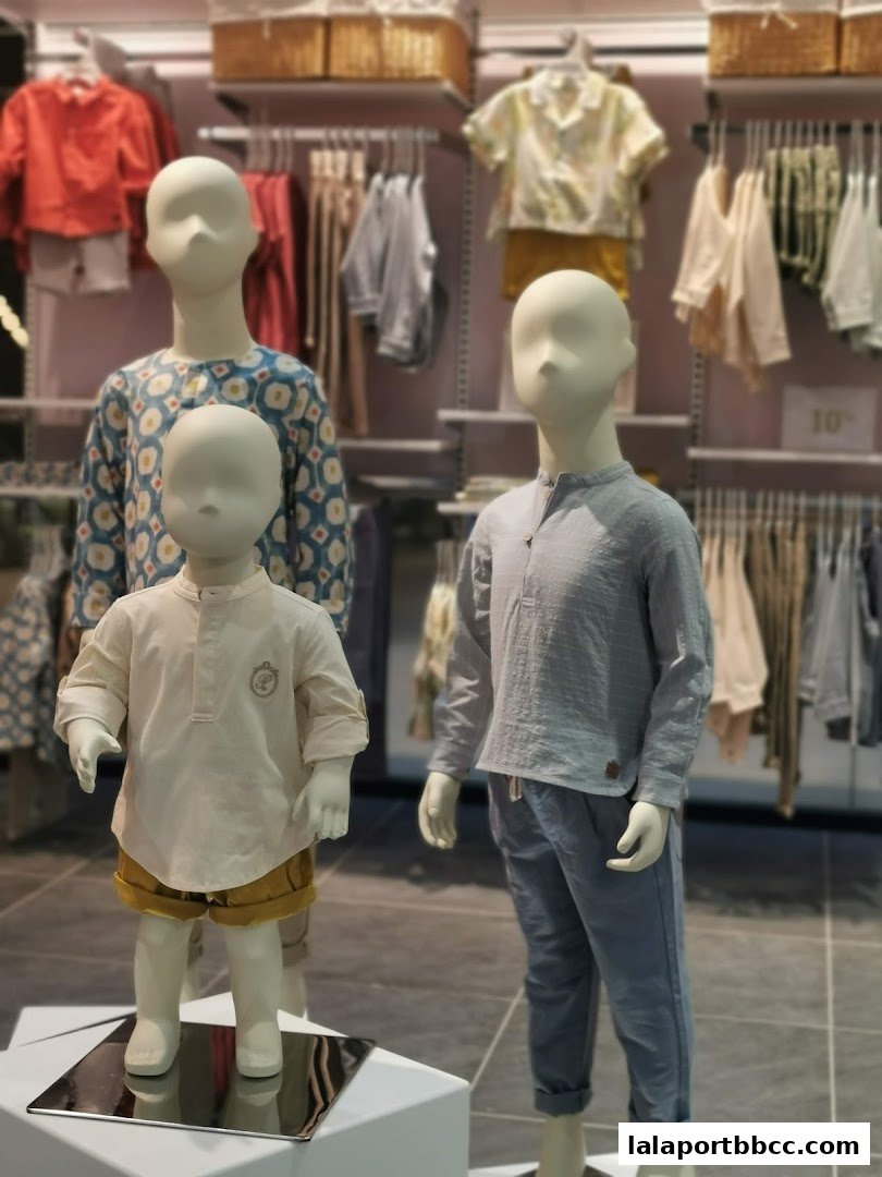 Mannequins display children's clothing, showcasing stylish outfits in a retail store.