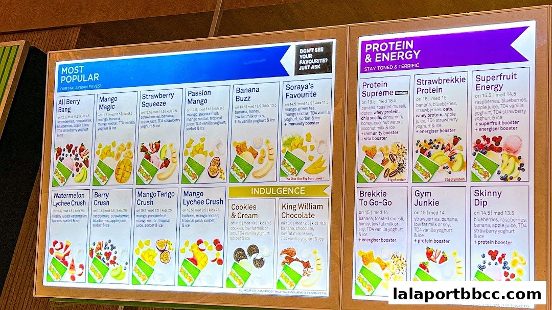 A brightly lit menu board displaying various smoothies and their ingredients and prices.
