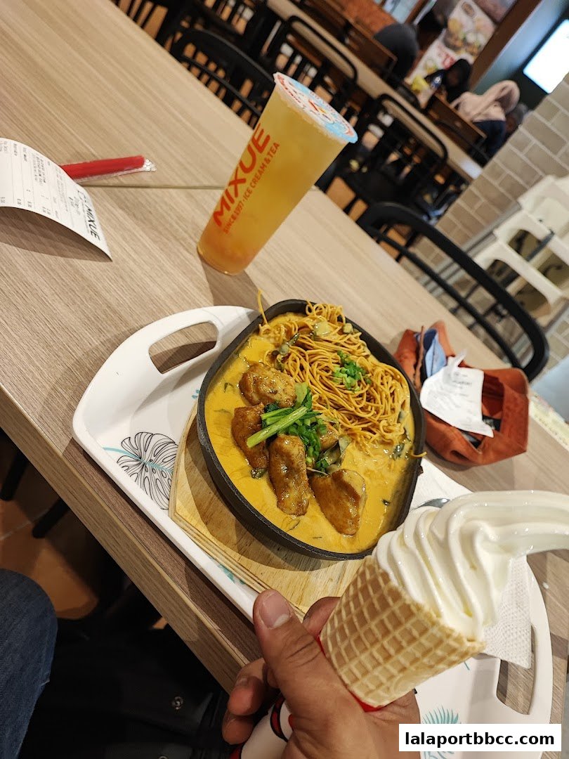 A table setting with a sizzling dish, a beverage, and an ice cream cone.