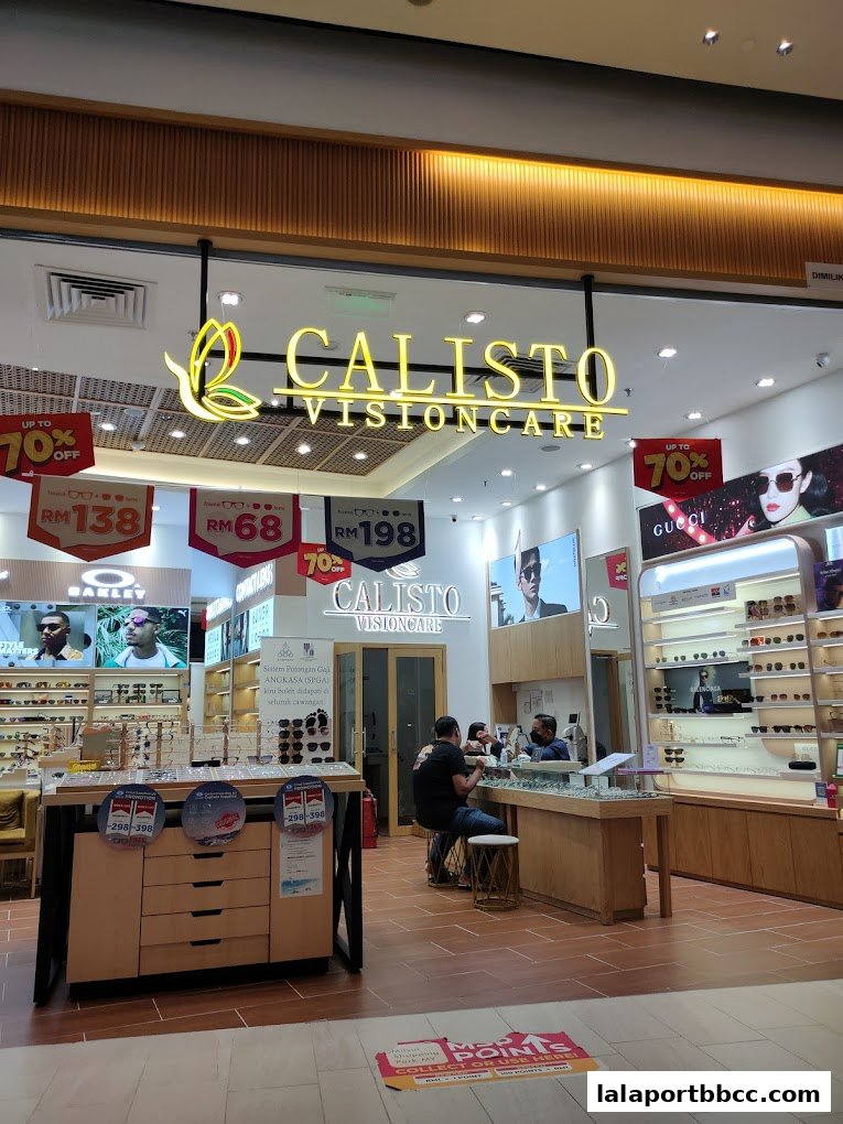 The exterior of Calisto Visioncare, an optical shop, with displays of glasses and promotional signs.