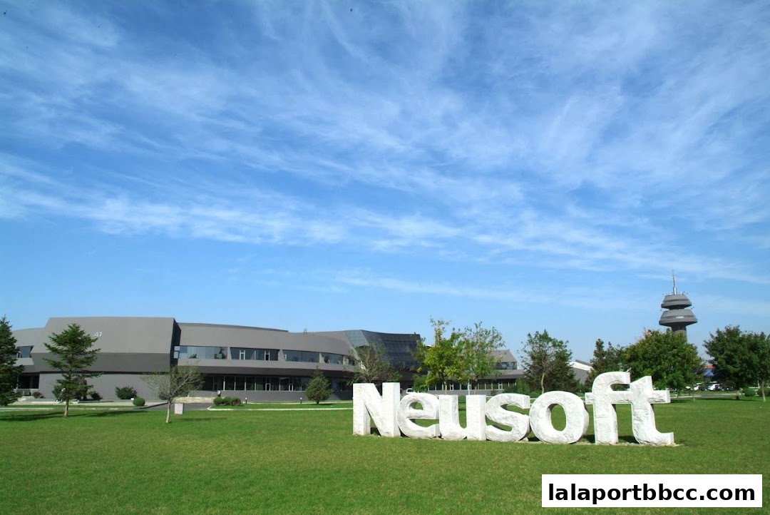 A modern office building with large 'Neusoft' lettering in front on a sunny day.