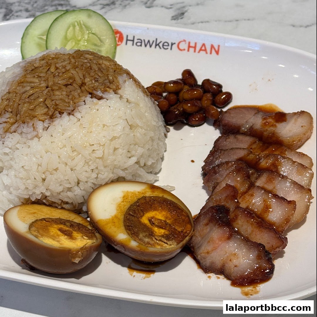 A plate of delicious char siu rice with braised egg and beans from Hawker Chan.