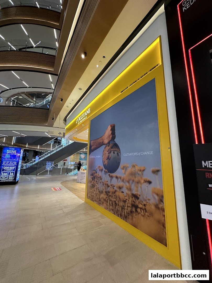 The L'Occitane en Provence shop front with a large promotional image and mall interior.