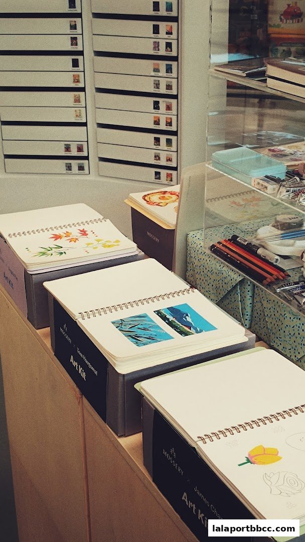 Notebooks and art supplies displayed on shelves in a retail store.