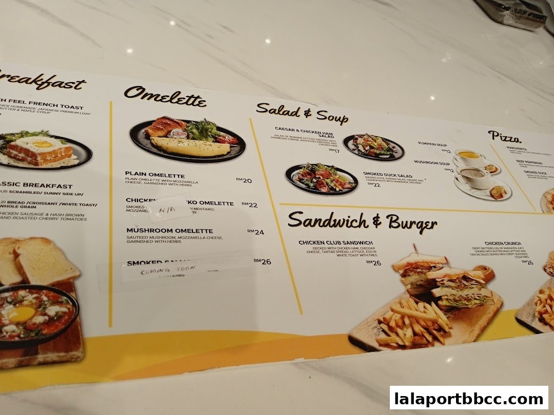 A menu featuring breakfast, omelettes, salads, soups, pizzas, sandwiches, and burgers with prices.