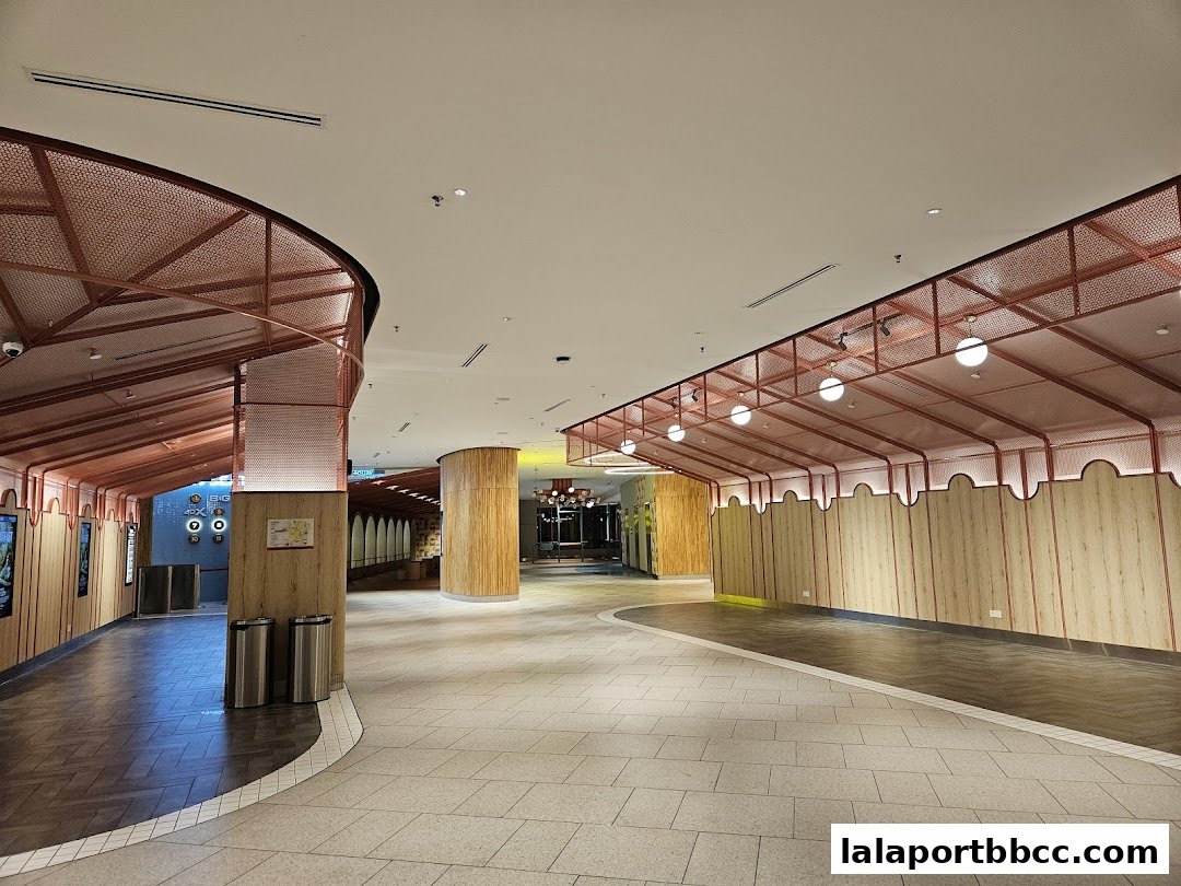 Interior view of a modern shopping mall walkway with distinctive architectural features.