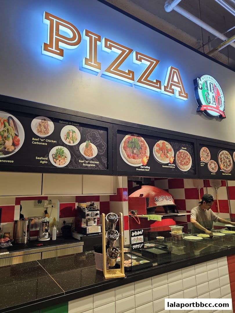 A pizza restaurant counter with a large 'PIZZA' sign and menu displays.
