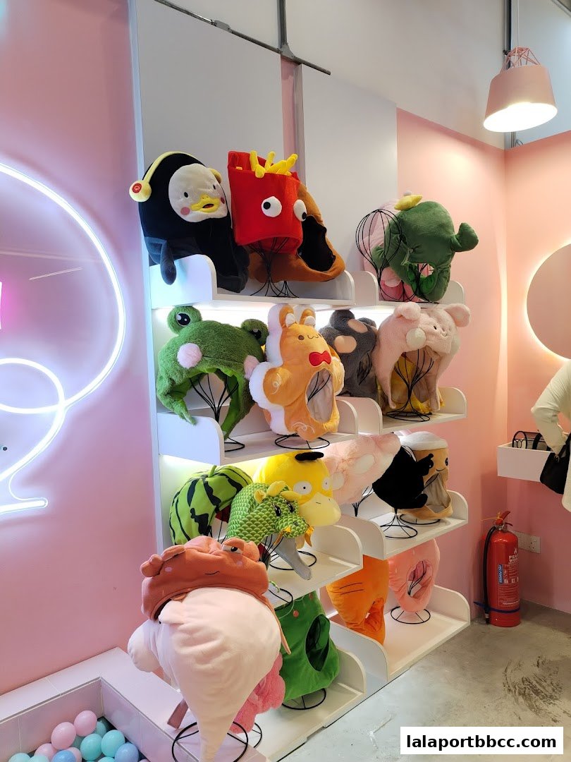 A display of fun, character-themed plush hats in a brightly lit shop.