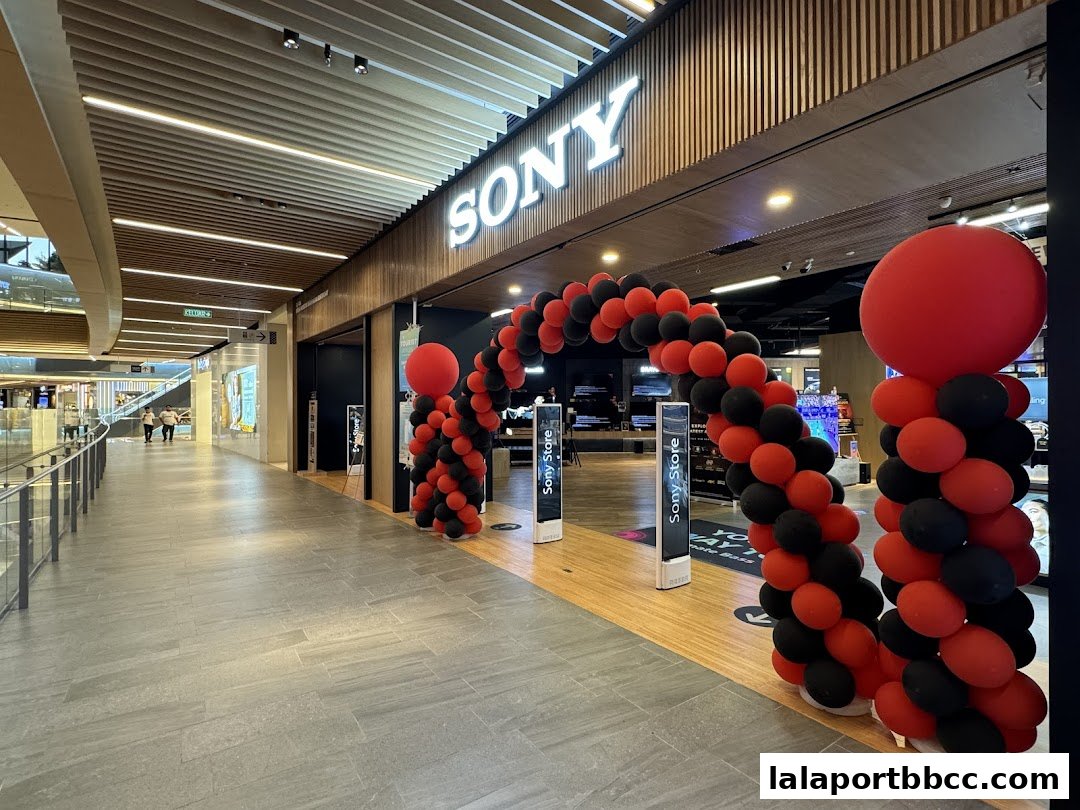 The entrance of a Sony Store decorated with red and black balloons for an event.