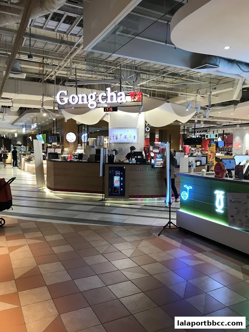 A Gong Cha bubble tea shop with customers ordering at the counter.
