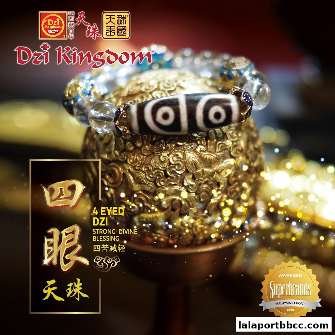 A close-up of a Dzi bead bracelet on an ornate golden stand, featuring the shop's logo.
