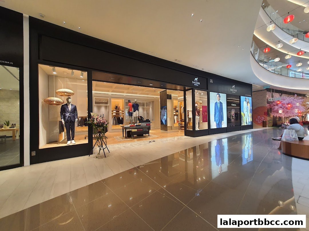 The Sacoor Brothers store features a well-lit interior with mannequins displaying stylish suits and casual wear.