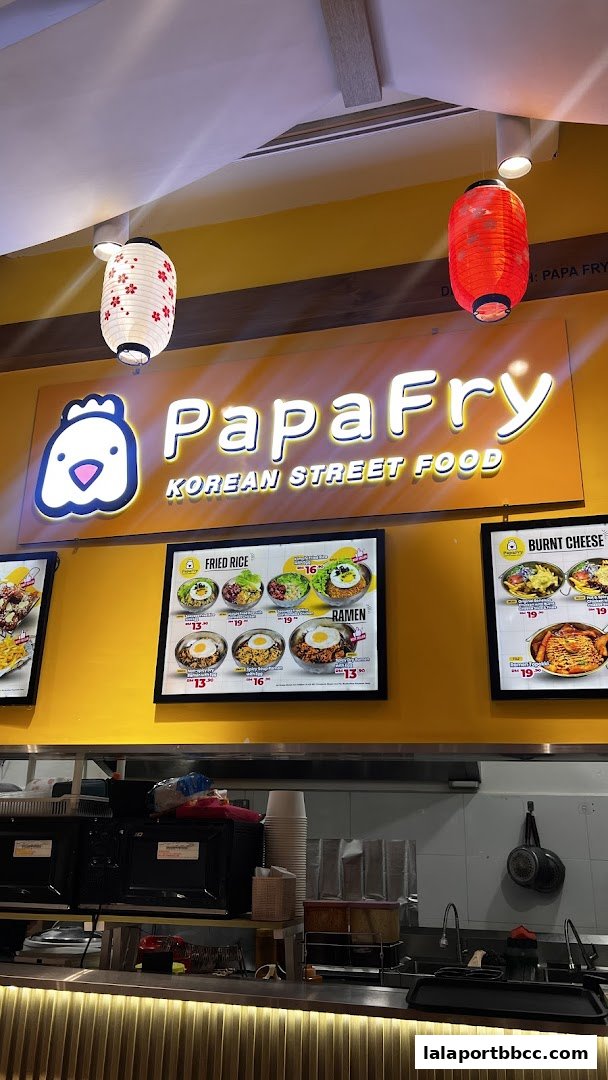 Papa Fry Korean Street Food shop front with menu displays and hanging lanterns.