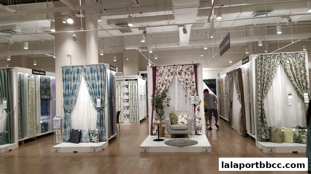 Interior view of a NITORI store showcasing a wide variety of curtains and window coverings.