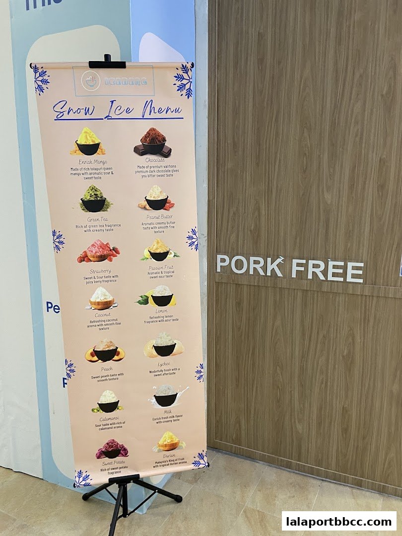 A menu board displays various flavors of Snow Ice from Iceberg.