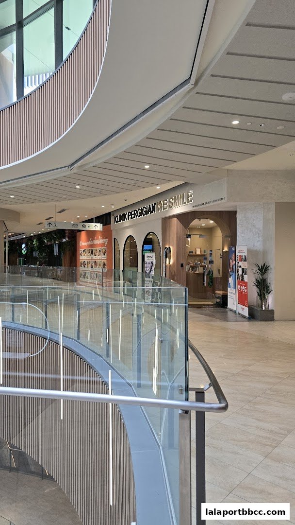 The entrance of WeSmile Dental Clinic at LaLaport BBCC, featuring modern architecture and signage.