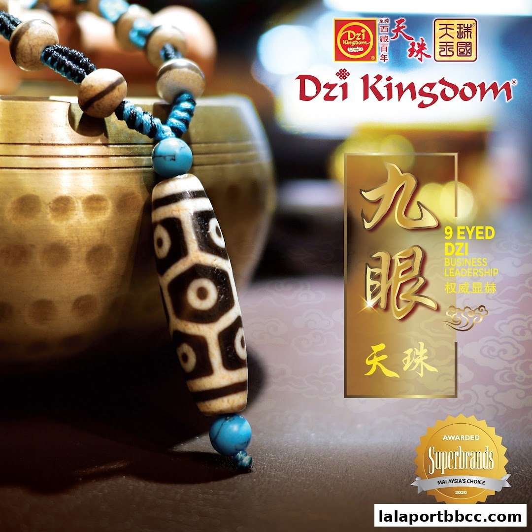 A close-up of a Dzi bead necklace with Tibetan singing bowls in the background.