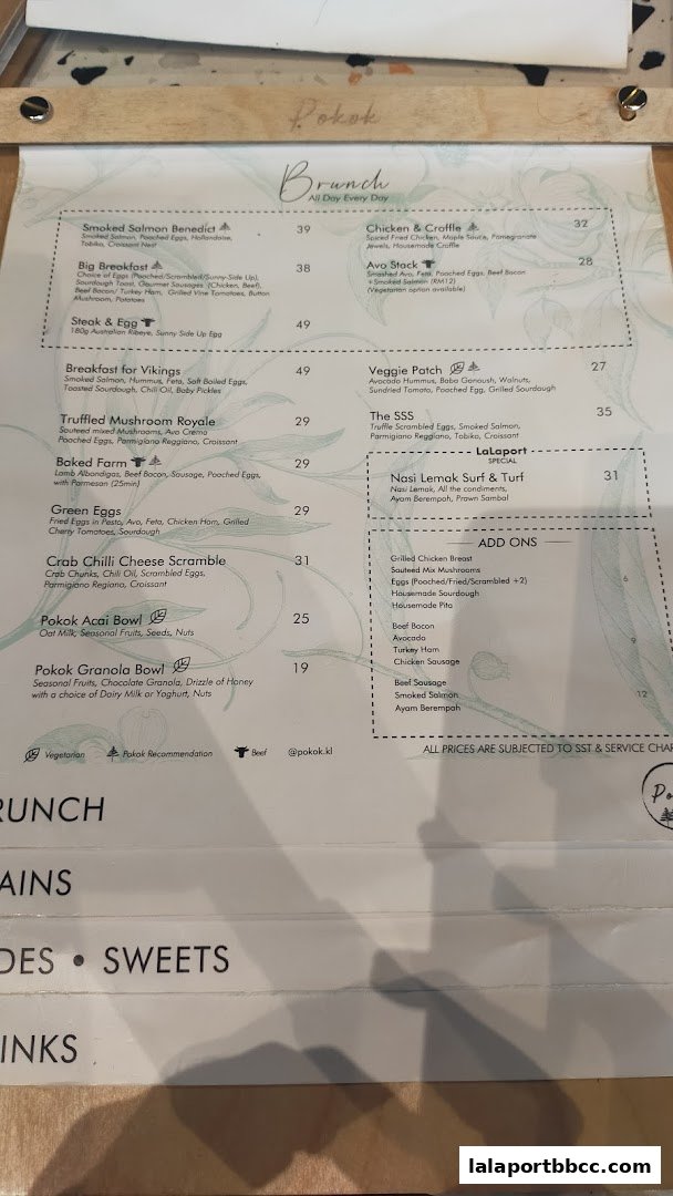 A menu from POKOK LaLaport featuring brunch items and add-ons.