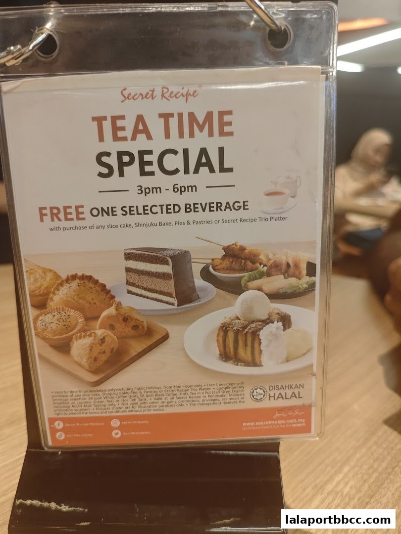 A Secret Recipe menu board advertising a Tea Time Special with a free beverage offer.