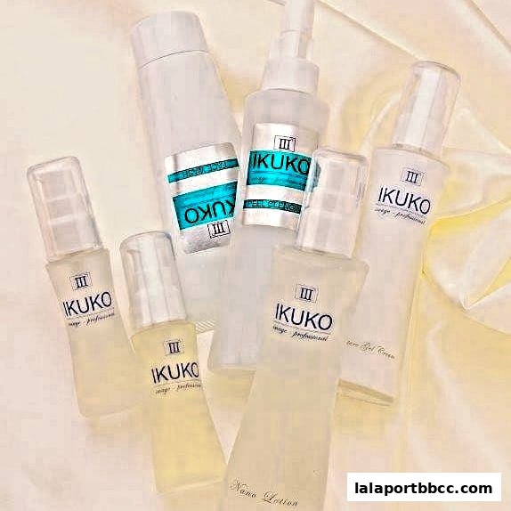 A collection of IKUKO JAPAN BEAUTY skincare products arranged on a silky white background.