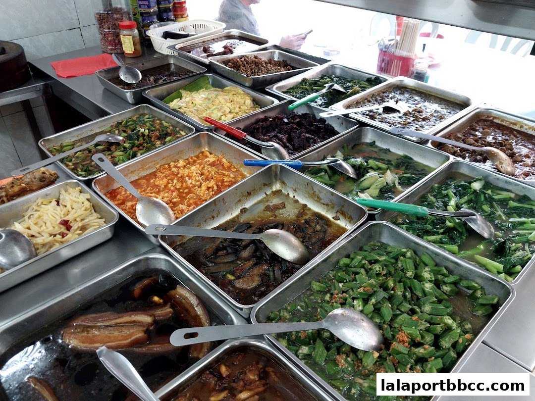 A variety of delicious dishes are displayed in metal trays, ready to be served.