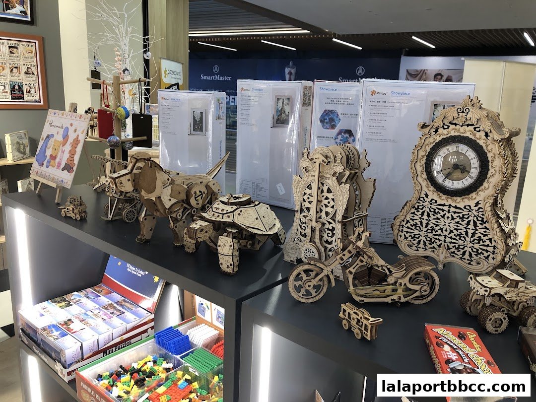 A display of intricate wooden 3D puzzles, including animals, vehicles, and a clock.